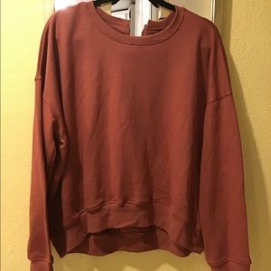 Sweater, rusty color with tie and grommets in back